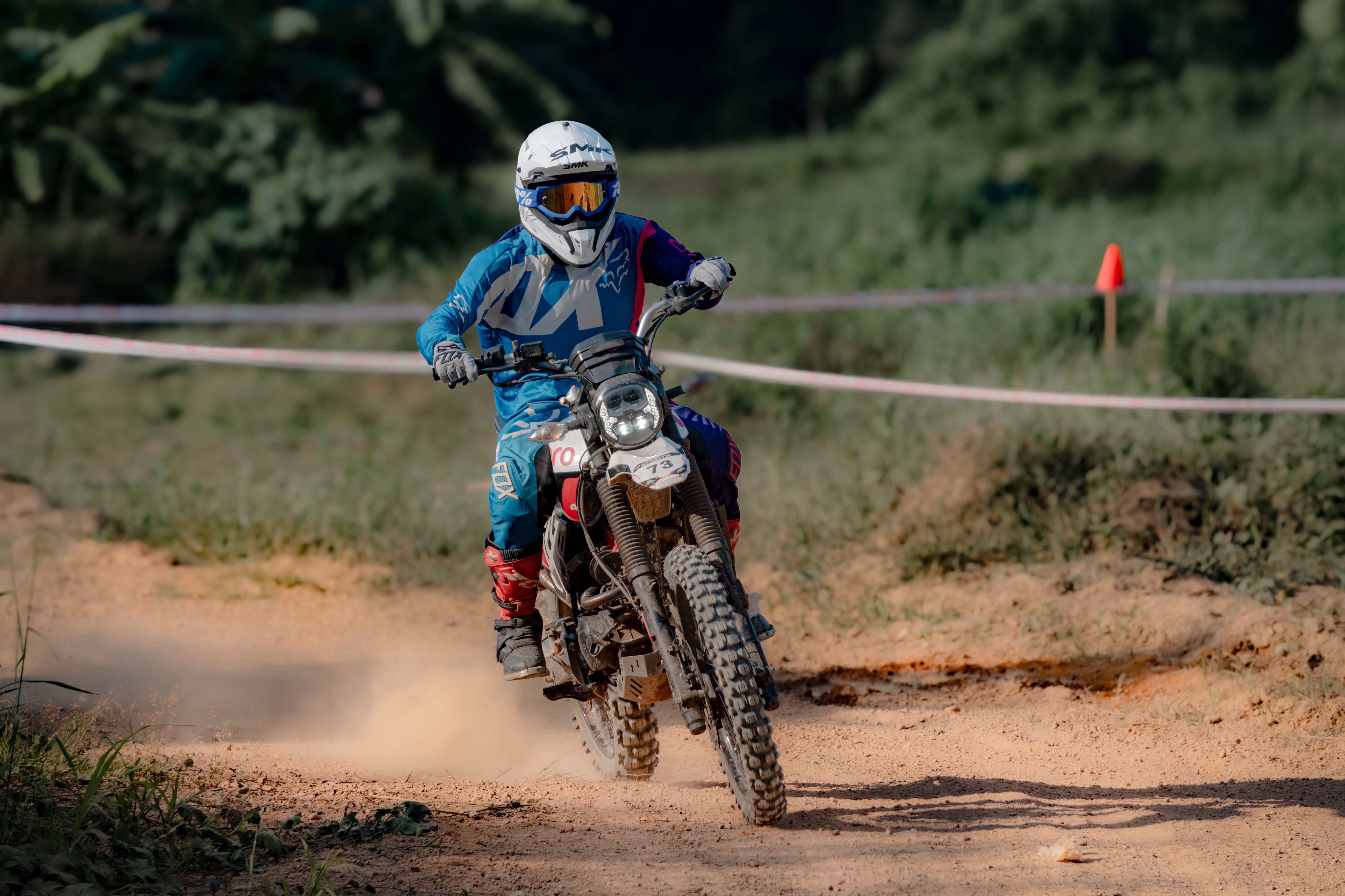 Dirt Bike Racer in Blue Gear on Dusty Track · Free Stock Photo