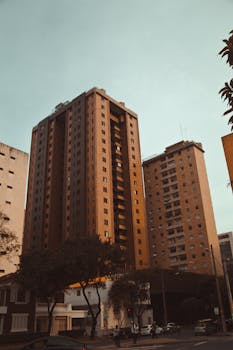 Tall apartment buildings set against the urban landscape of Belo Horizonte, Brazil.