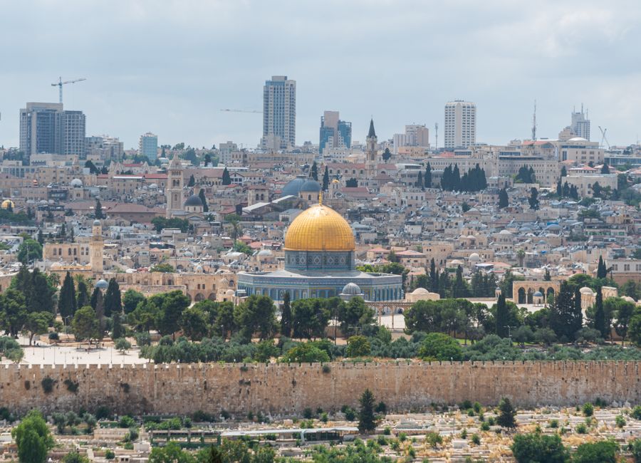 Captivating aerial view of the Dome of the Rock with Jerusalem's skyline in the background.