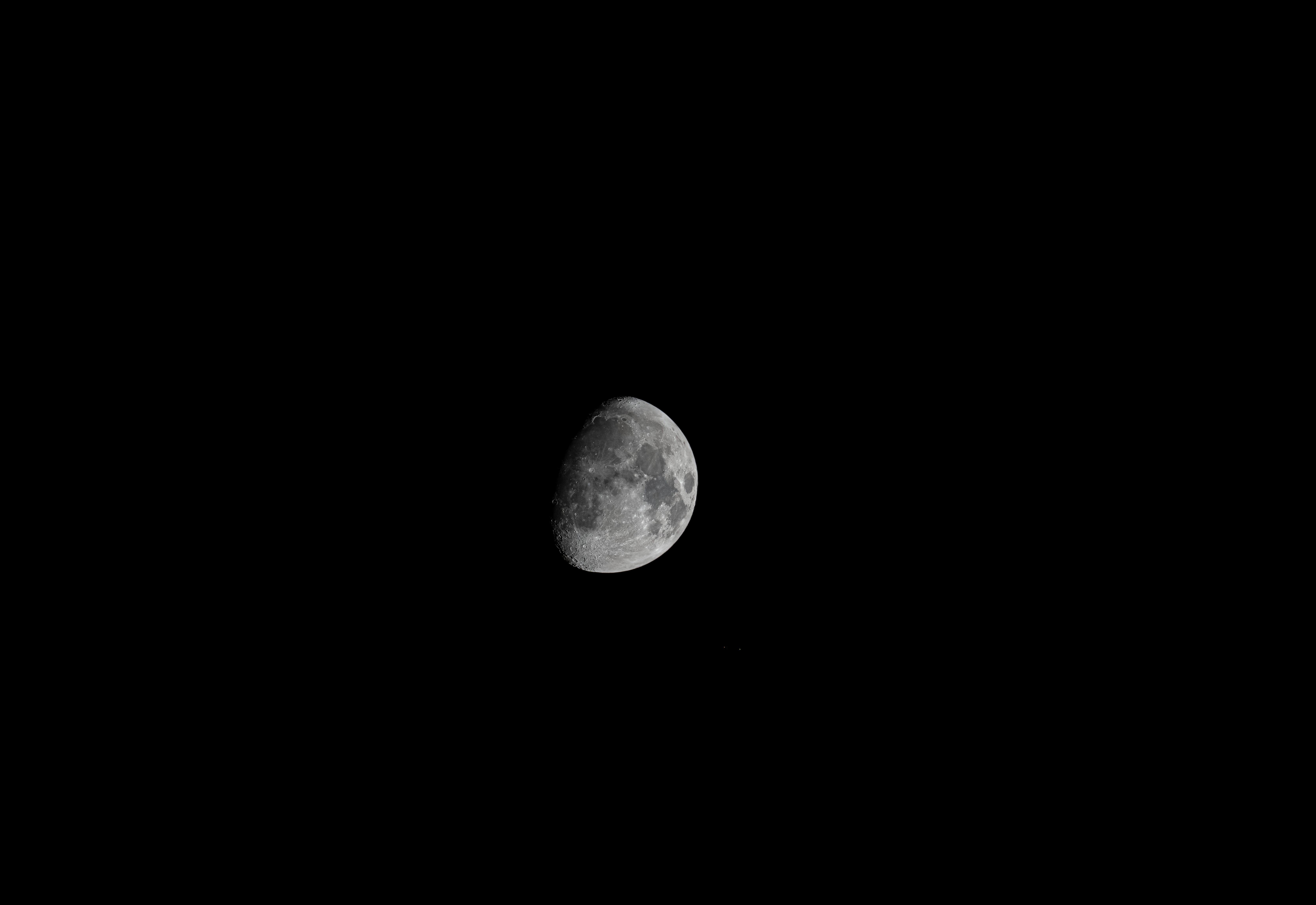 High-resolution image of the moon showcasing detailed craters and lunar features against a black backdrop.