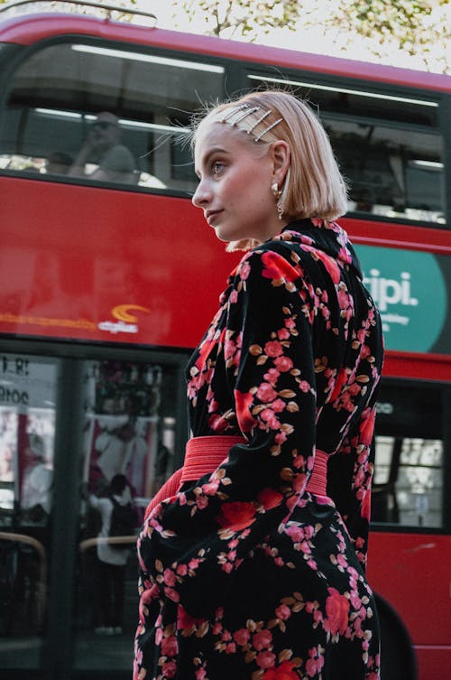 Woman Wearing Black and Red Floral Long-sleeved Dress Standing Near Red Double-deck Bus