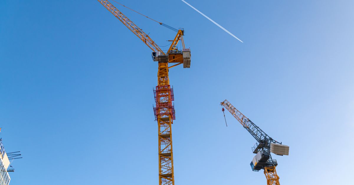 Construction cranes over a Toronto condo site, showing Canada's housing supply and new home starts