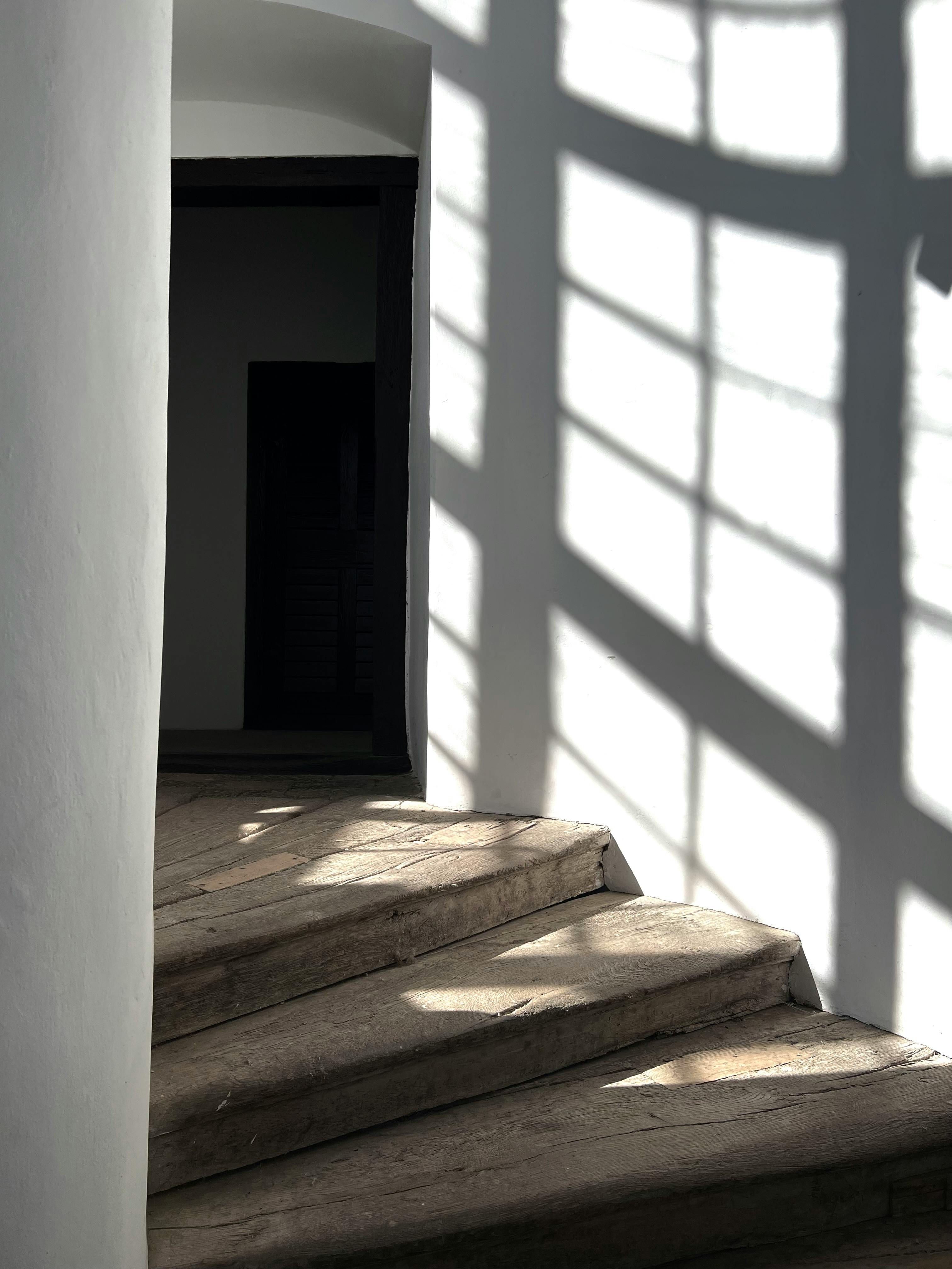 Elegant play of shadows on a wooden staircase in Békéscsaba, Hungary