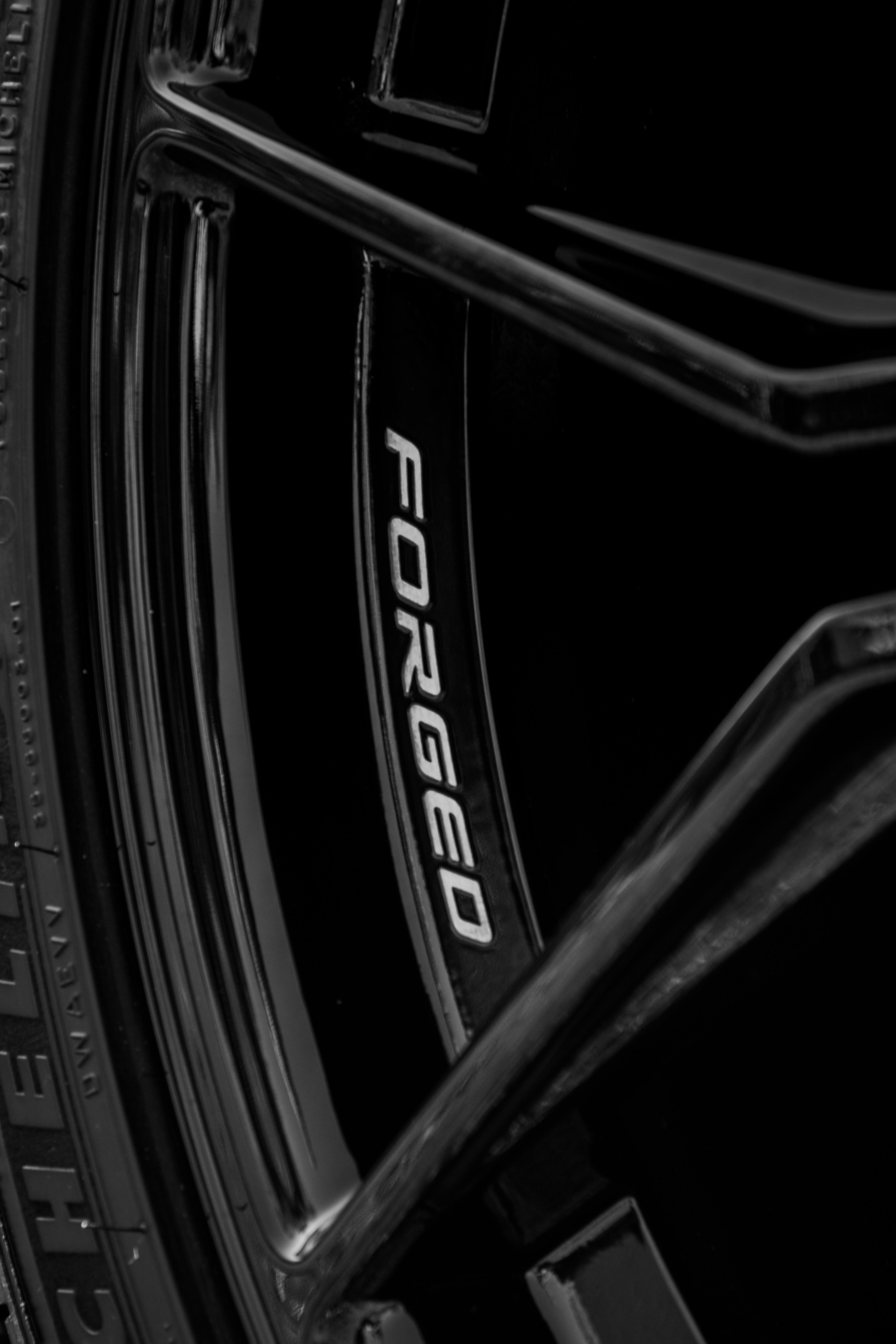 無料 洗練されたデザイン要素を備えた黒の鍛造合金ホイールのクローズアップ。 写真素材