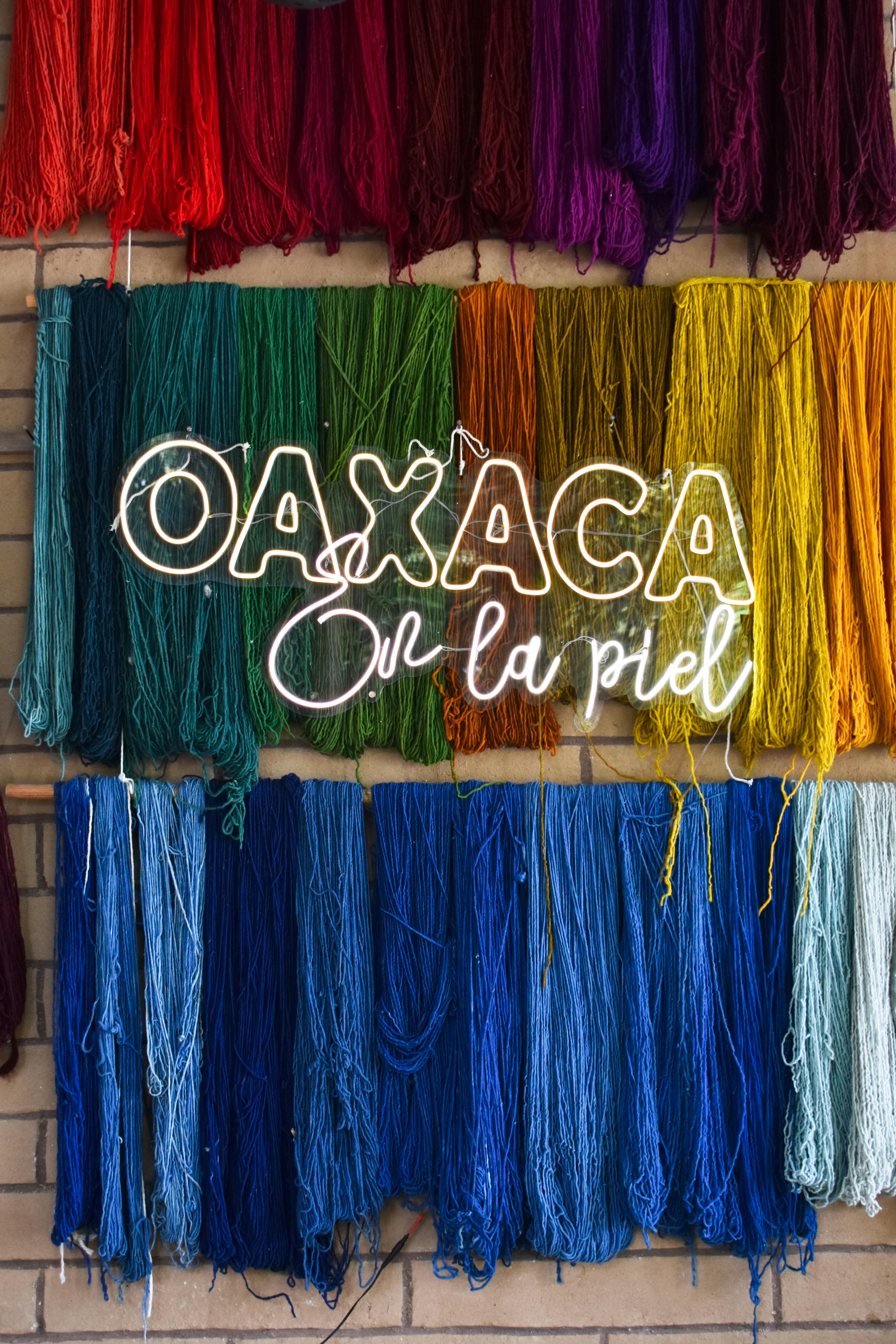 Vibrant yarns displayed in Oaxaca de Juárez with a neon 