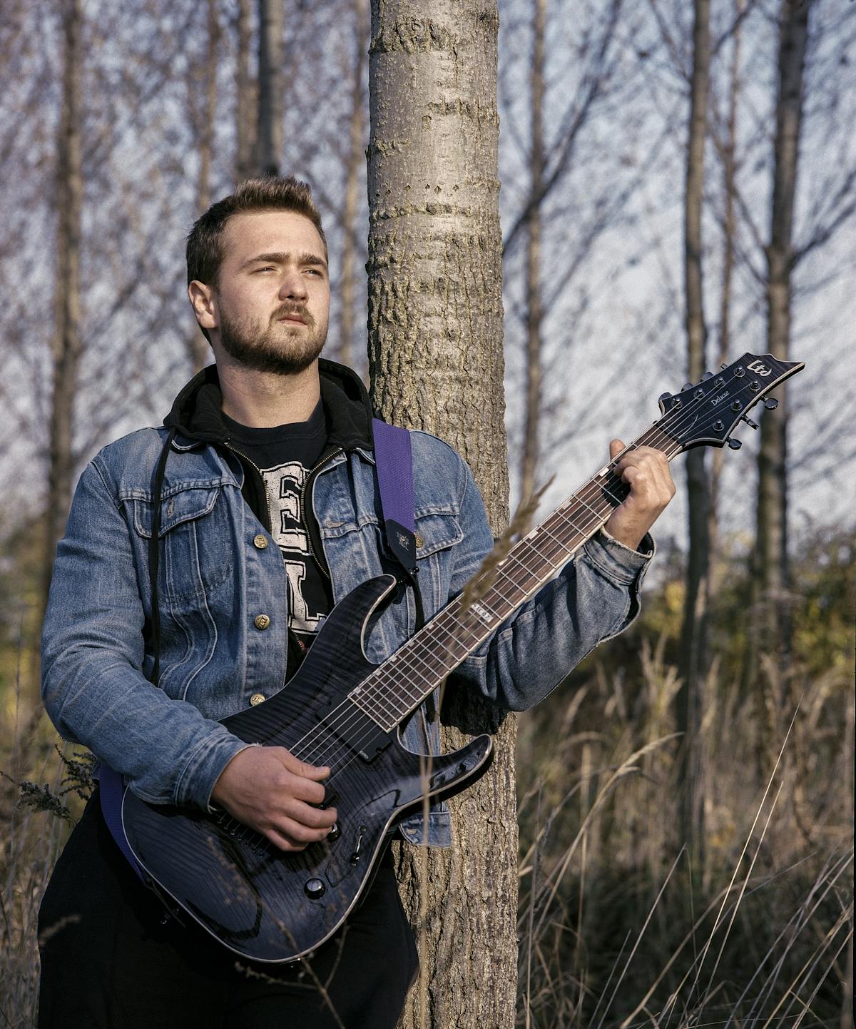 A quarterback dropping back to pass as offensive linemen block defenders