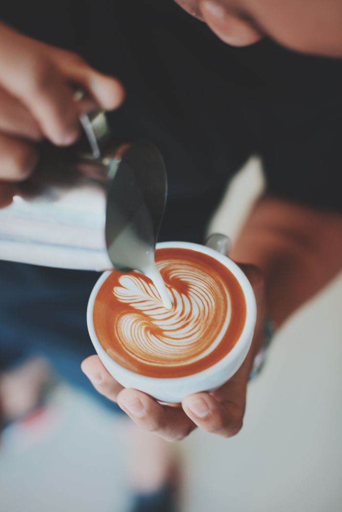 Barista pouring latte art
