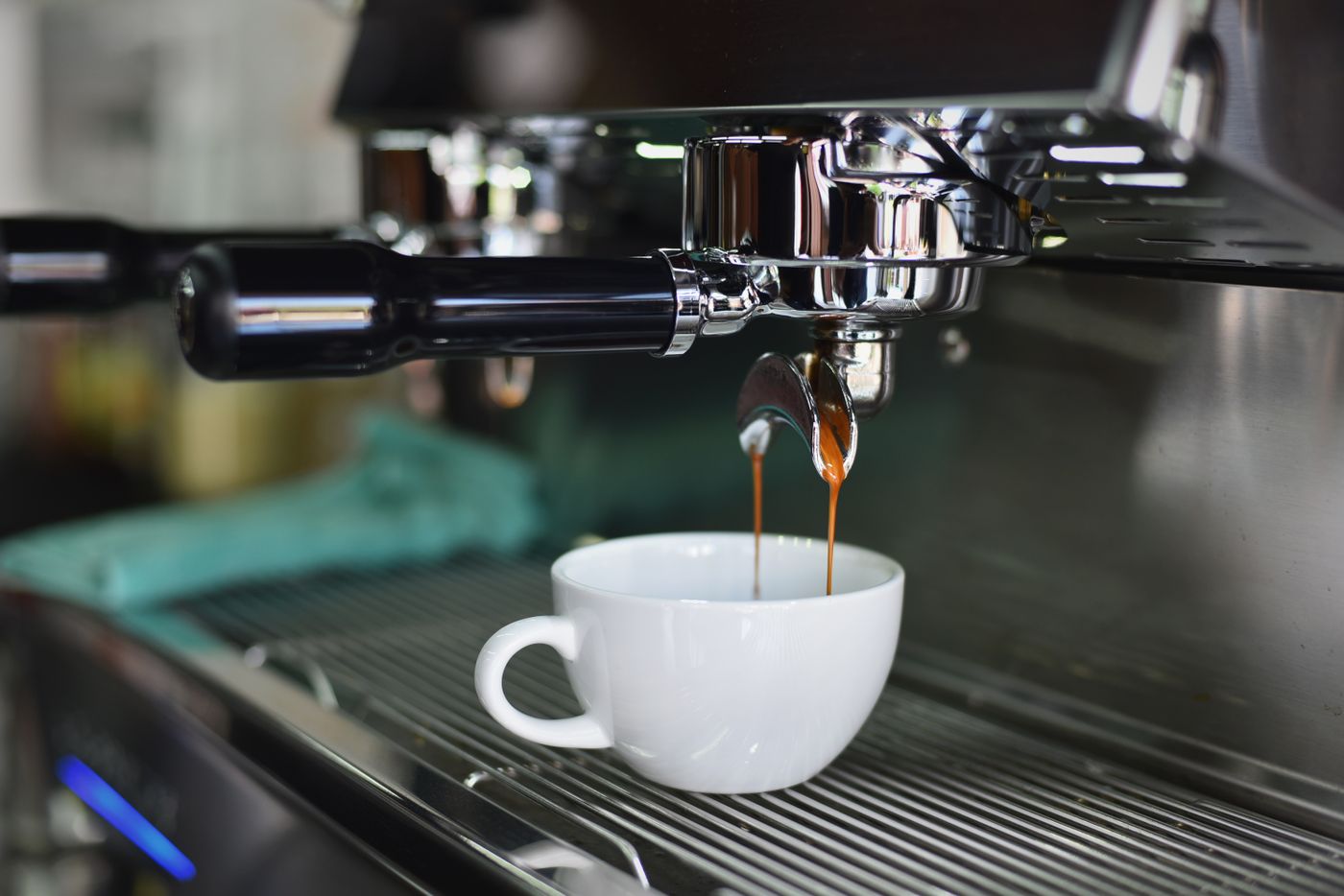 Espresso pulling into a white cup