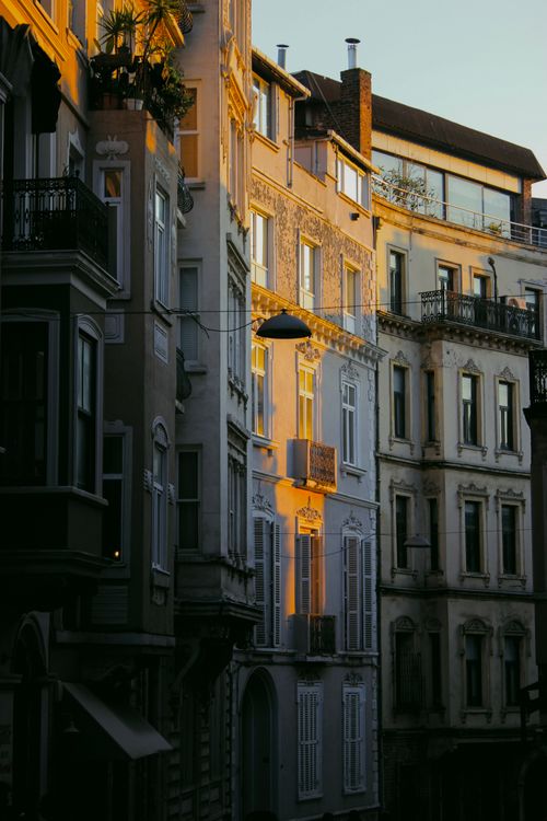 Free Warm sunlight illuminating classic European buildings at sunset, showcasing architectural beauty. Stock Photo