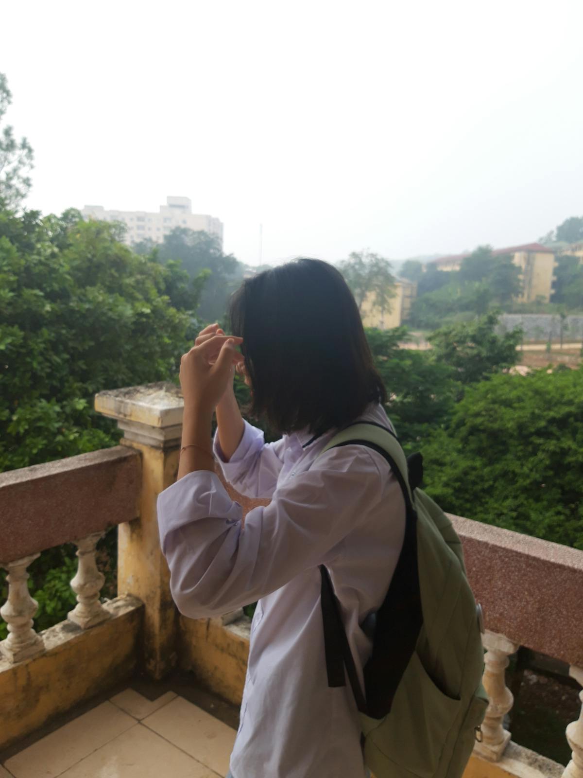 Barista pouring steamed milk into a mug, creating a latte