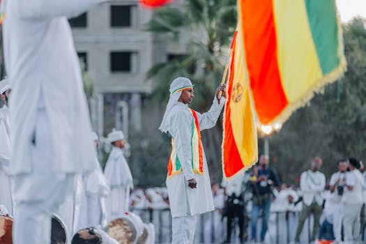 A traditional ceremony with Ethiopian flag in Addis Ababa, featuring cultural attire and vibrant colors.