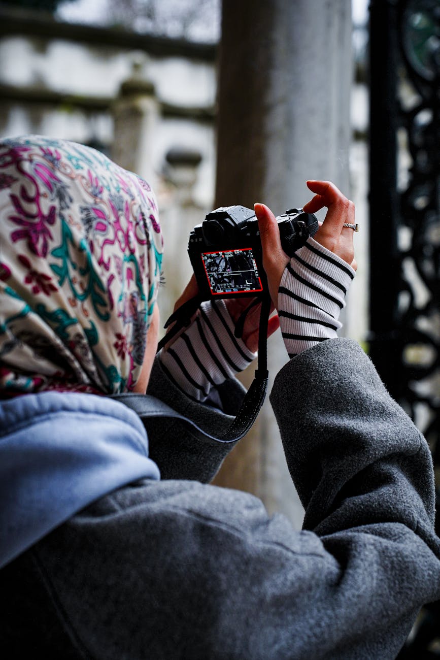 A young female photographer capturing architectural beauty outdoors.