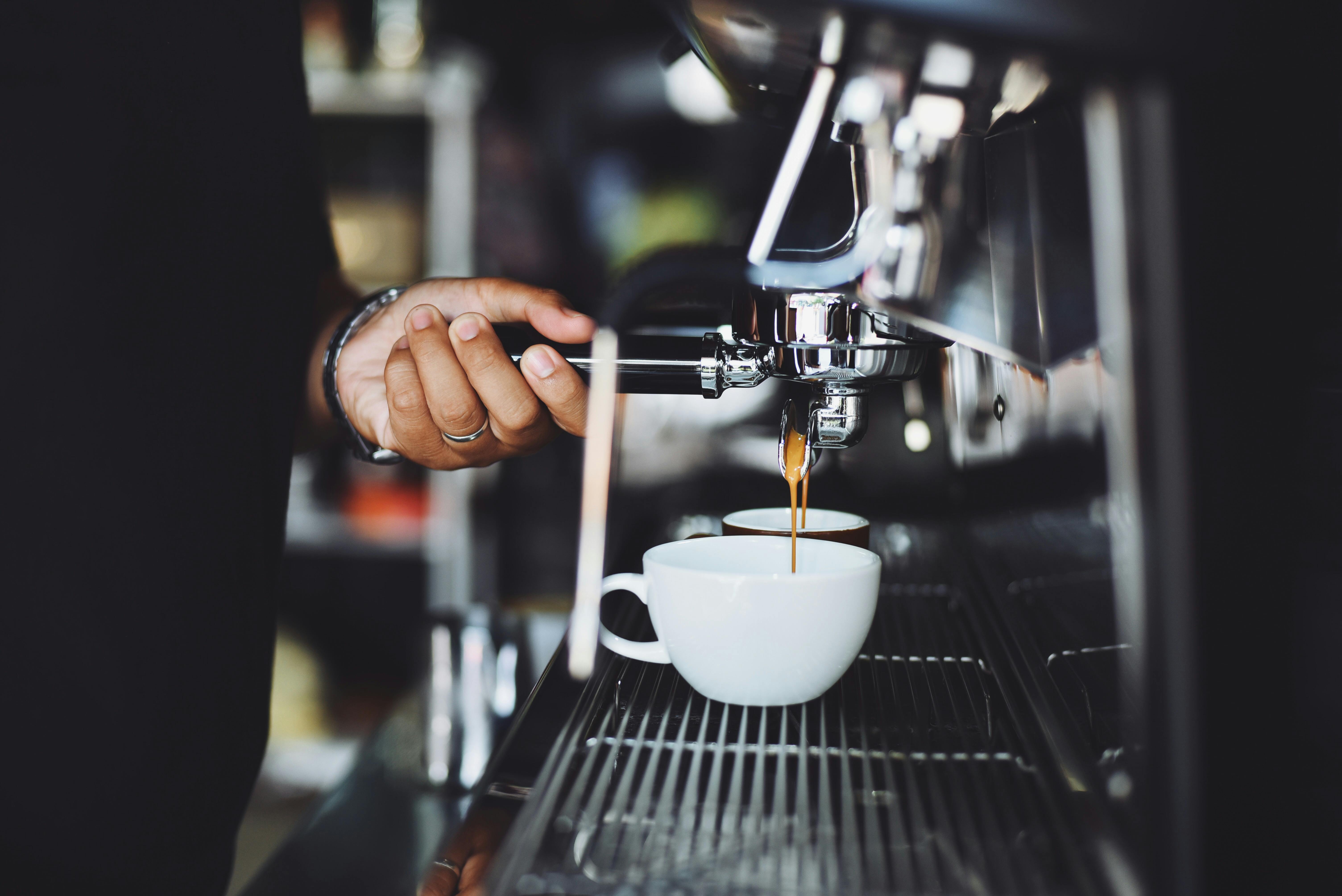 close up of hand holding coffee machine