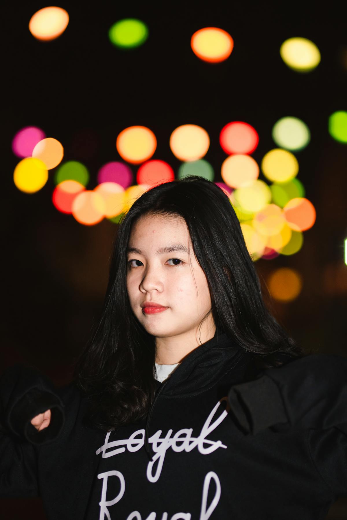 A person holding a warm, foamy latte with latte art