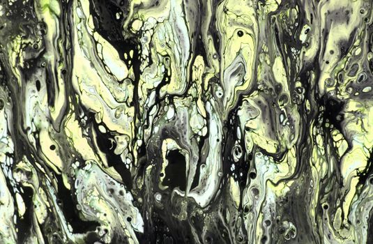 Dynamic fluid art painting featuring green and black swirling patterns, capturing artistic and abstract essence.