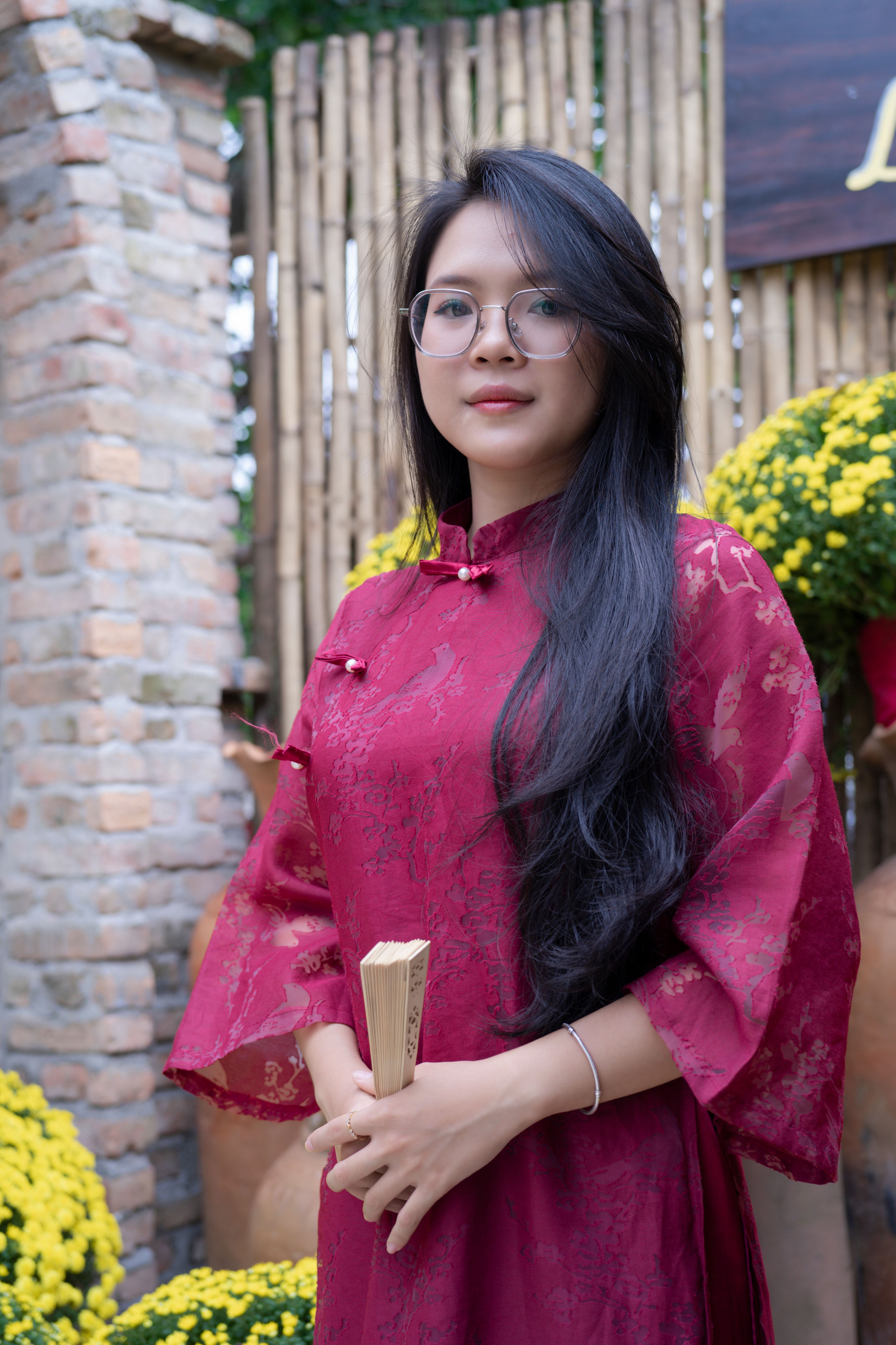 Elegant Woman in Red Dress with Bamboo Background