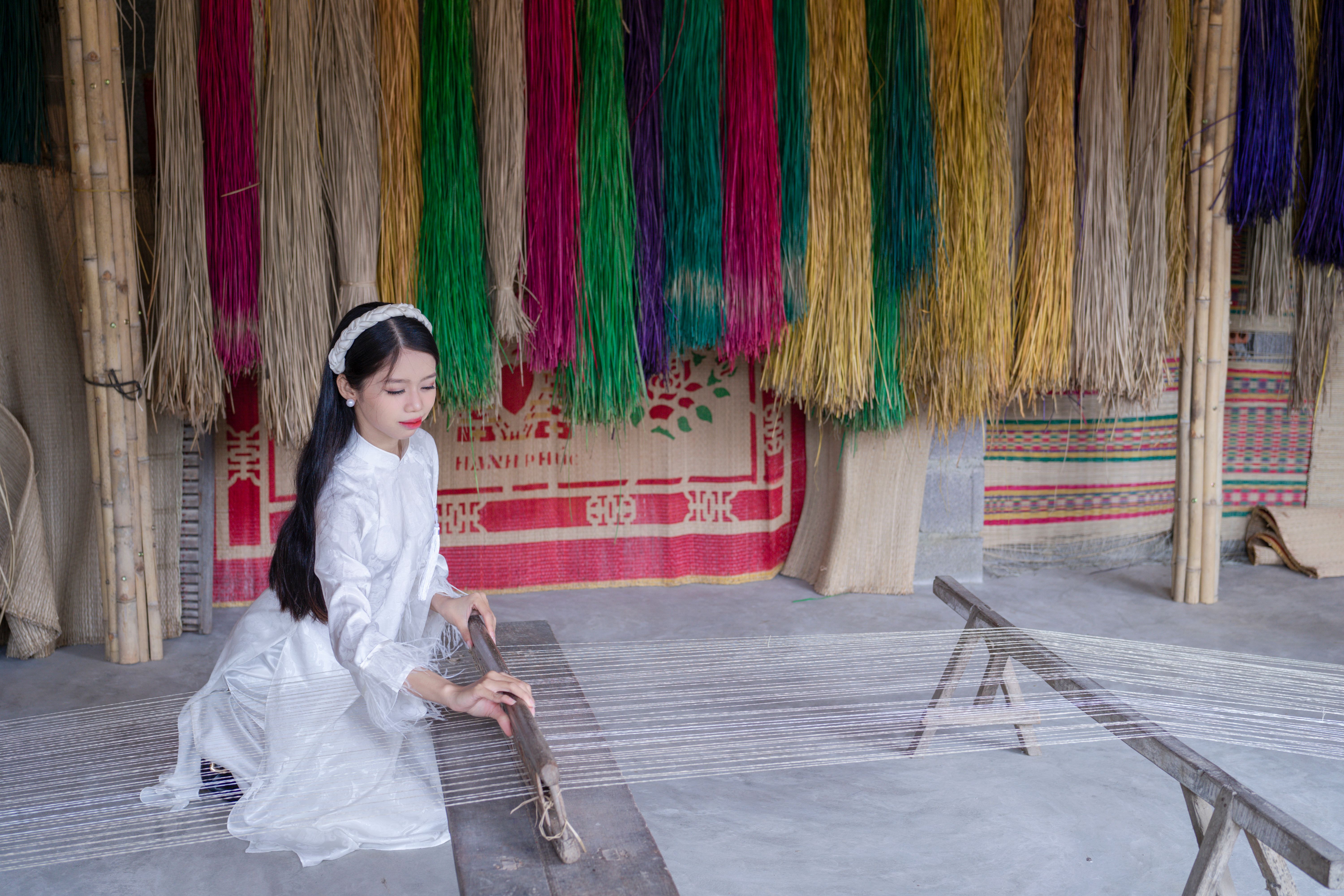 indigenous woman weaving traditional textile, colorful threads