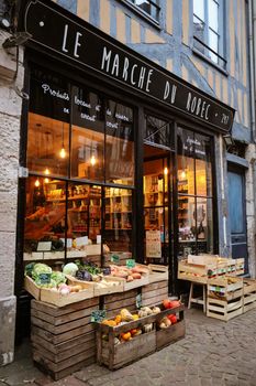 A quaint French market in Rouen featuring fresh produce and rustic charm.