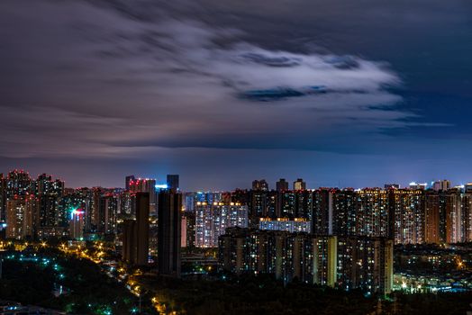 A stunning urban skyline illuminated at dusk, showcasing modern architecture and vibrant city lights.