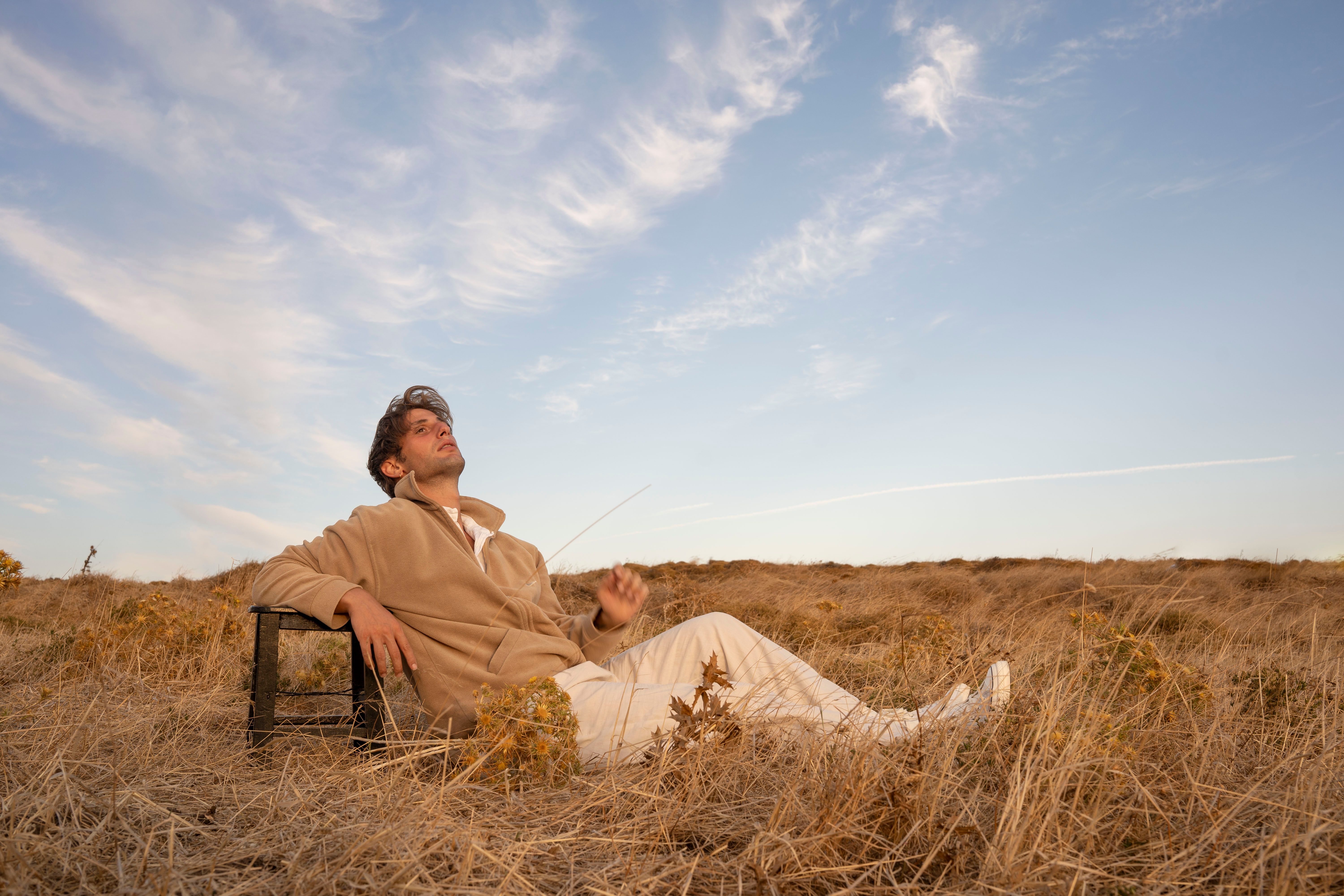 Relaxing Man in Scenic Autumn Field at Daytime · Free Stock Photo