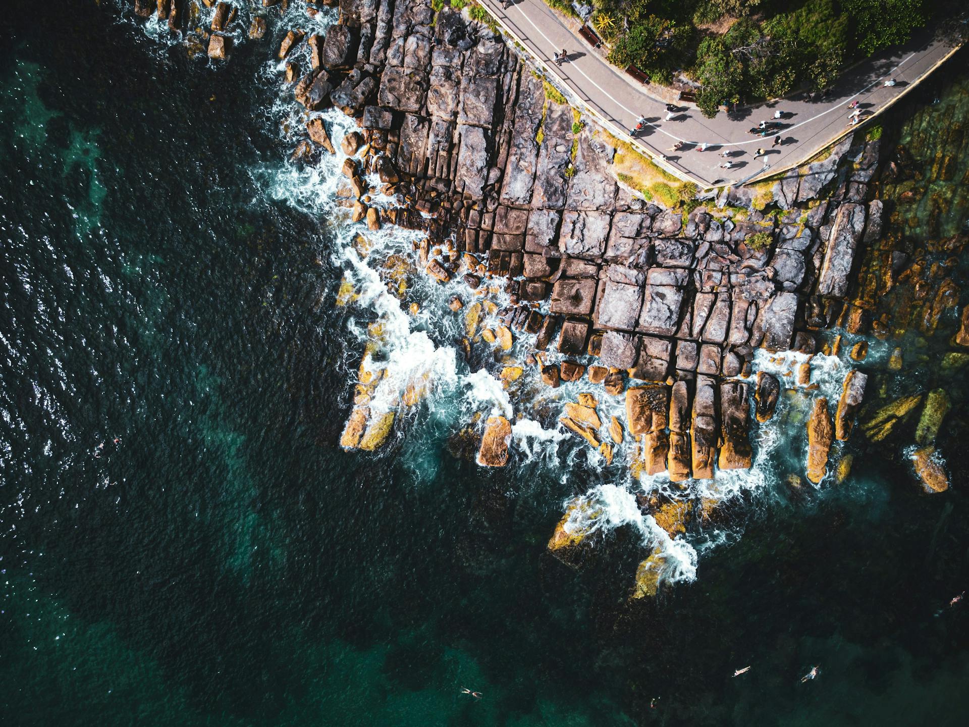 Stunning aerial shot of Manly, New South Wales showcasing rugged coastline and clear ocean waters.