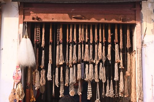 Free A display of handcrafted beads and necklaces at a traditional market stall, showcasing artisanal craftsmanship and cultural heritage. Stock Photo