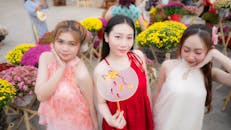 Joyful Asian Women Celebrating Outdoors with Flowers