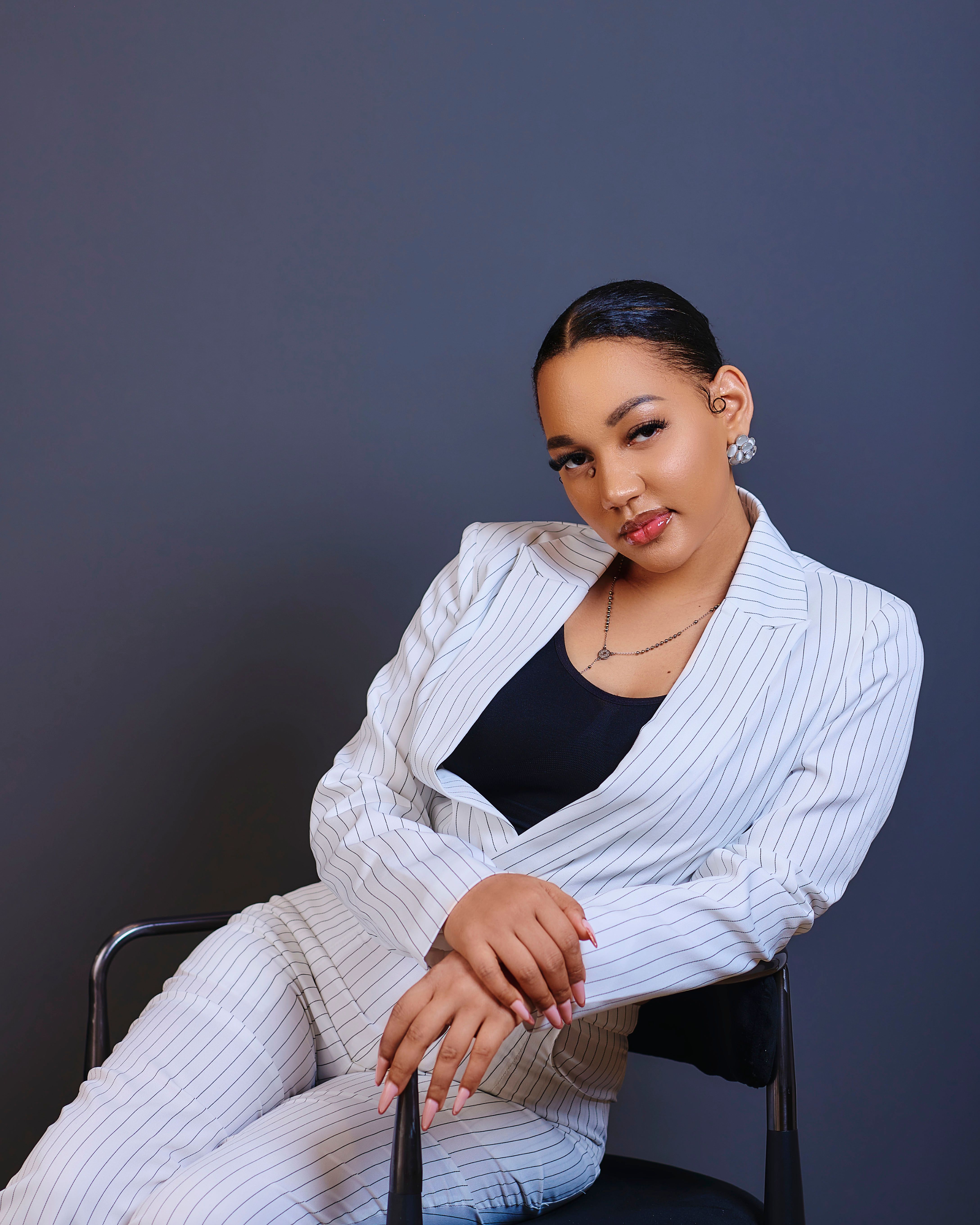 Confident Woman Posing in Stylish White Suit · Free Stock Photo