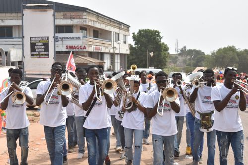 Free Lively street parade featuring diverse brass musicians performing outdoors. Stock Photo