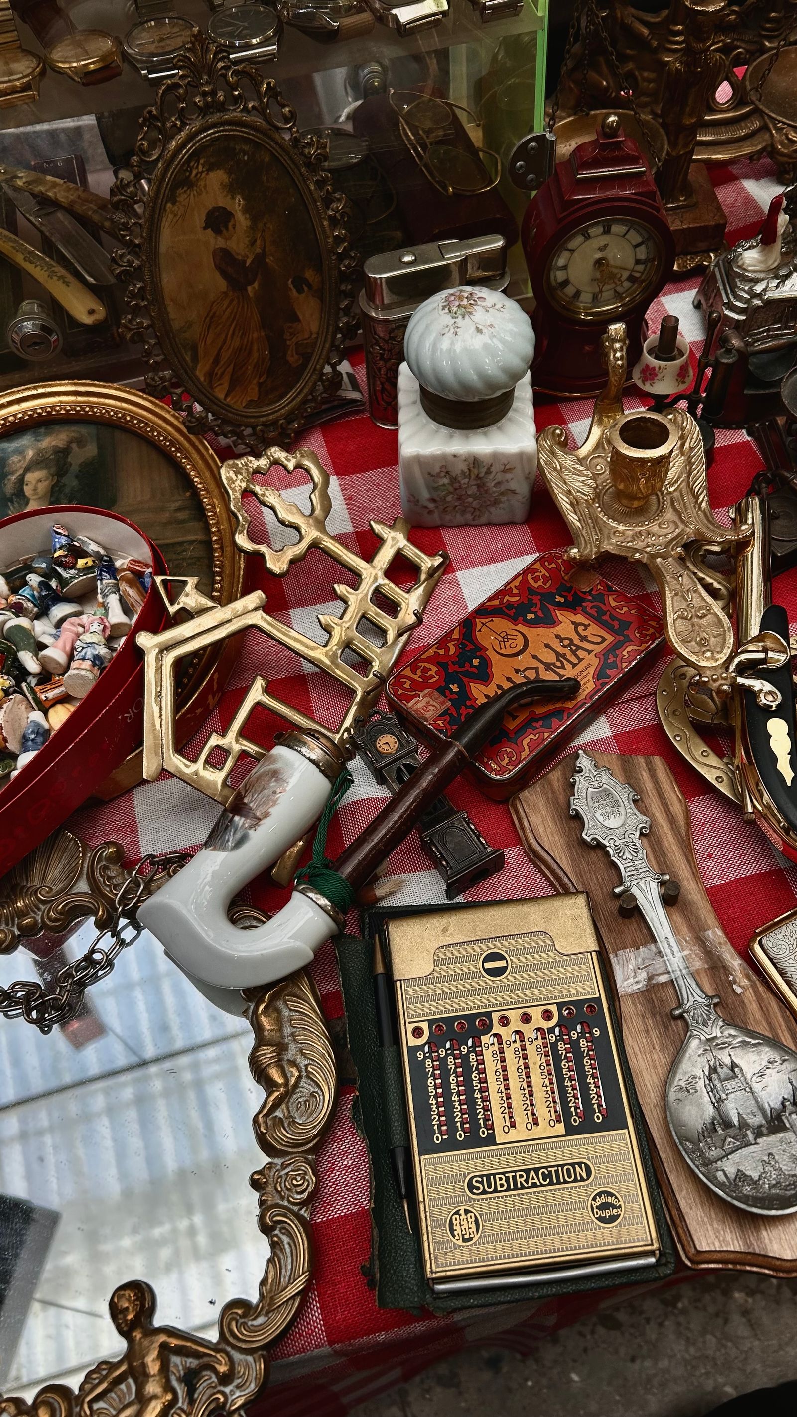 Antiques and collectibles laid out on a table, ready to be sold through an online auction