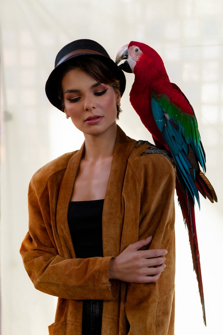 Dreamy Woman With Parrot Sitting On Shoulder