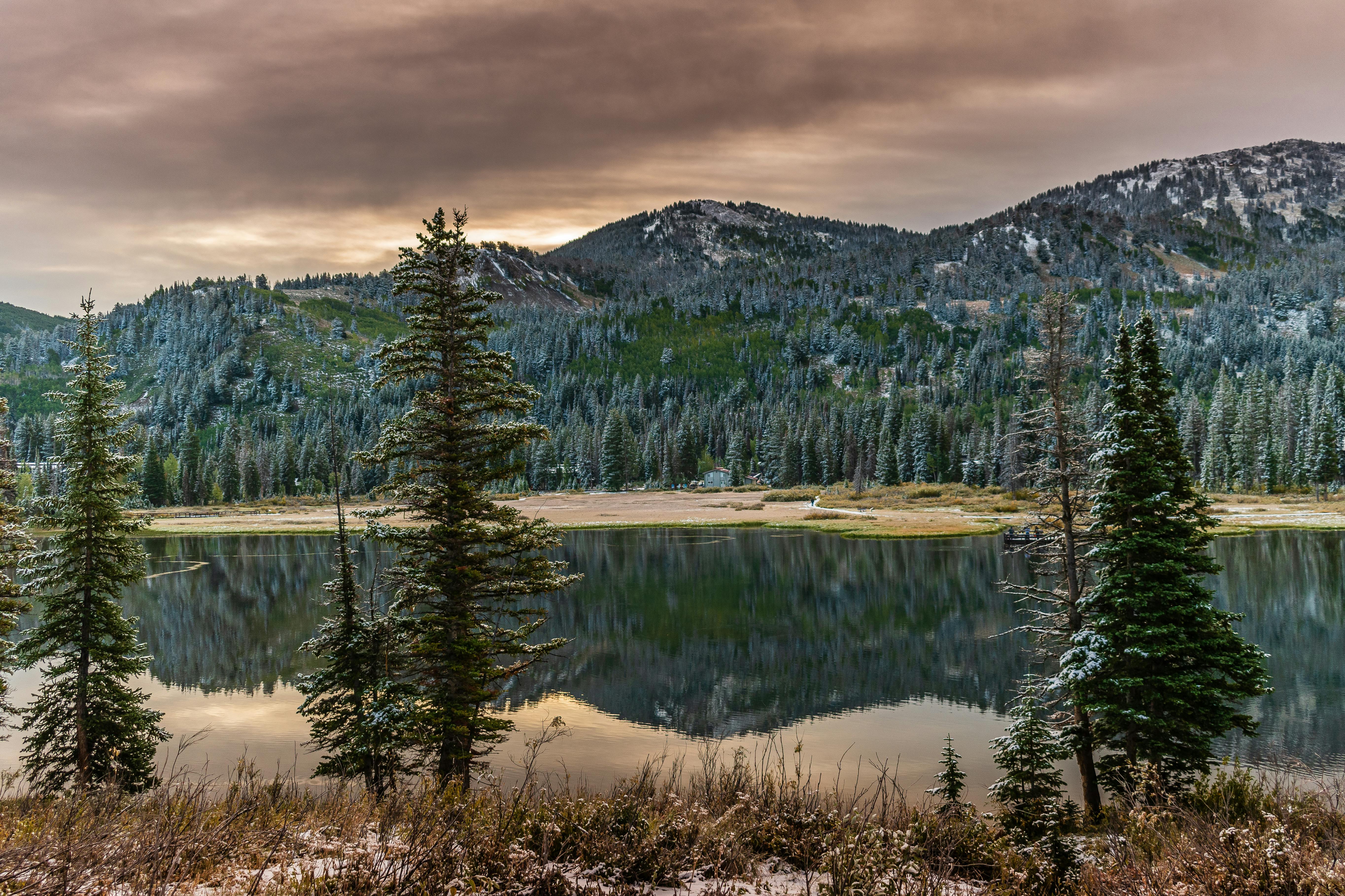 Prescription Goggle Inserts - Tranquil mountain lake with pine forest reflection and snowy peaks in Utah, USA.