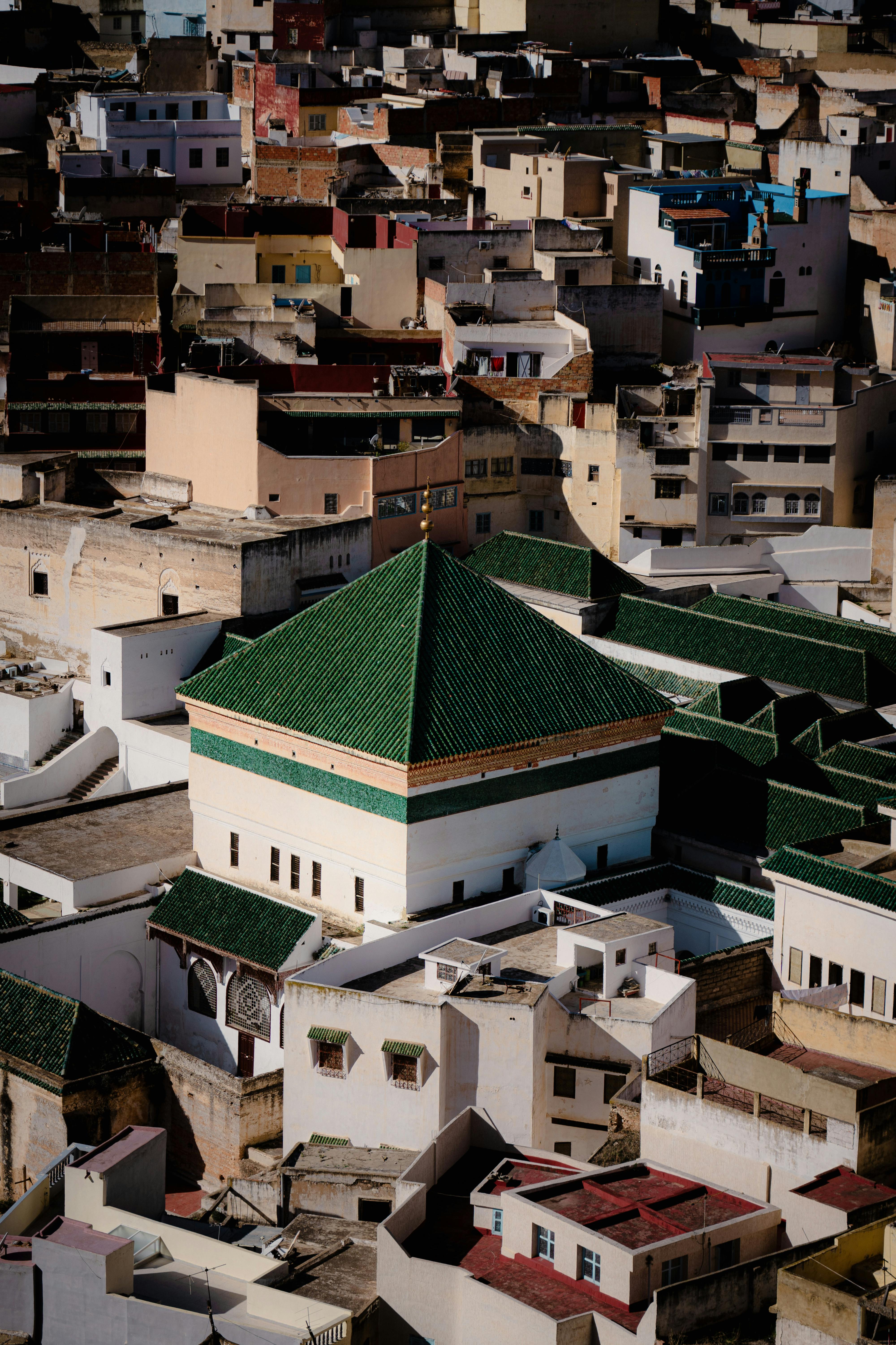 Explore the vibrant rooftops and traditional architecture of a Moroccan city from above.