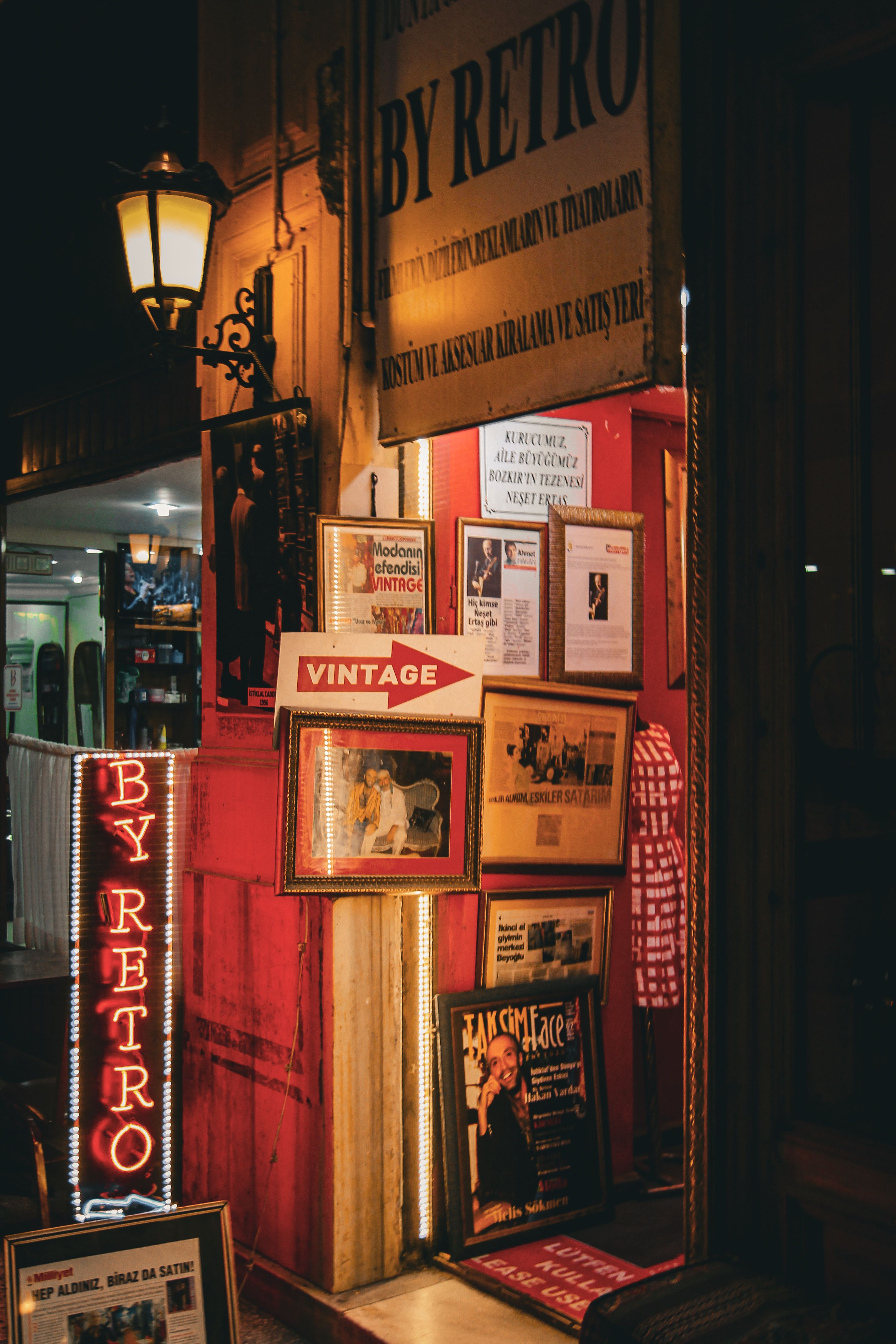 A charming vintage shop entrance glowing warmly at night in Istanbul.