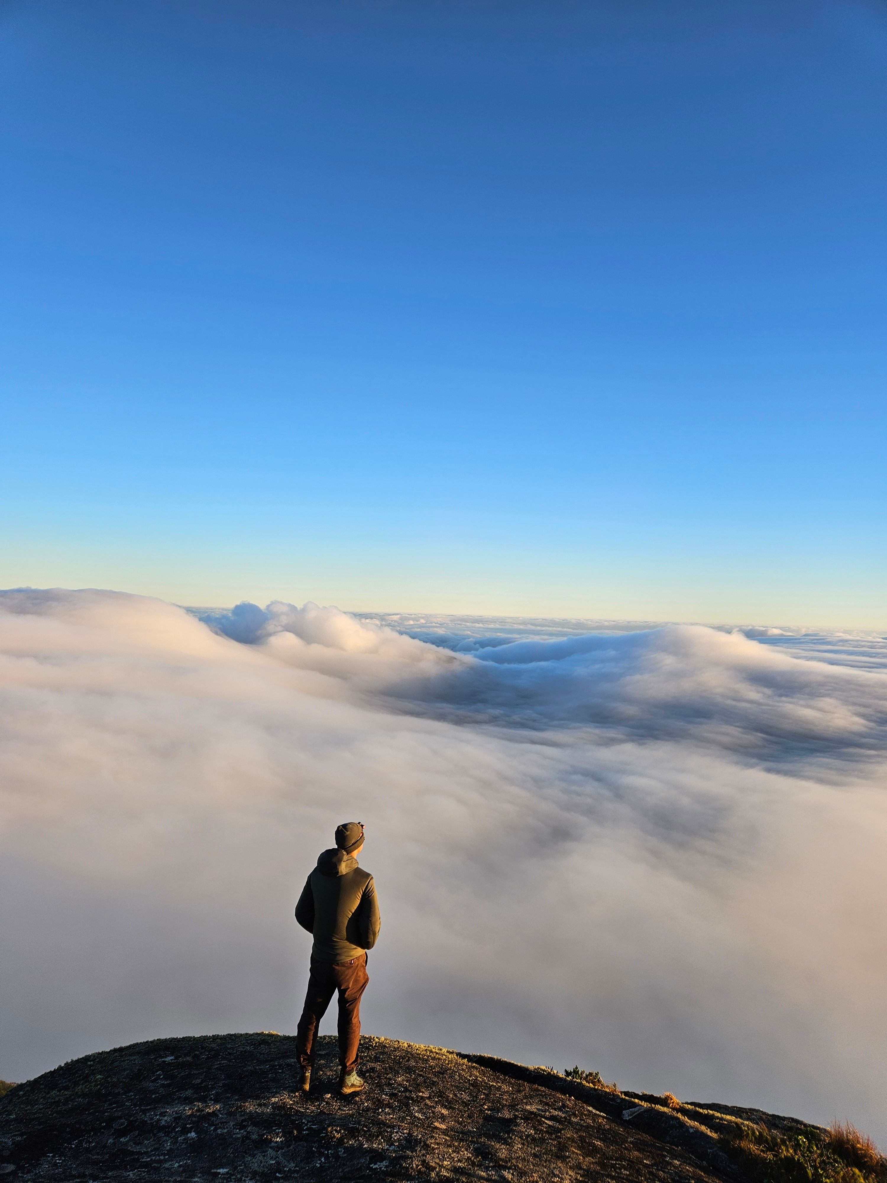 Silhouette of a Man Standing on a Mountain · Free Stock Photo