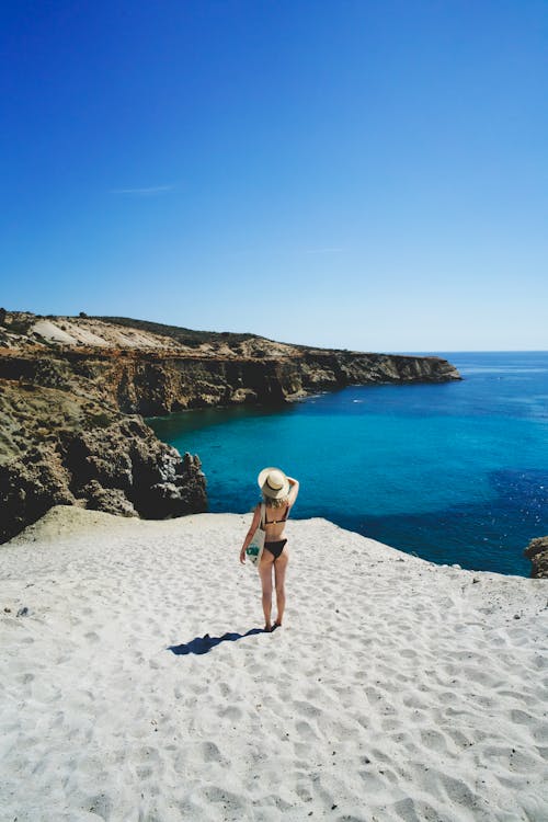 Free Woman Standing at a Sandy Cliff Stock Photo