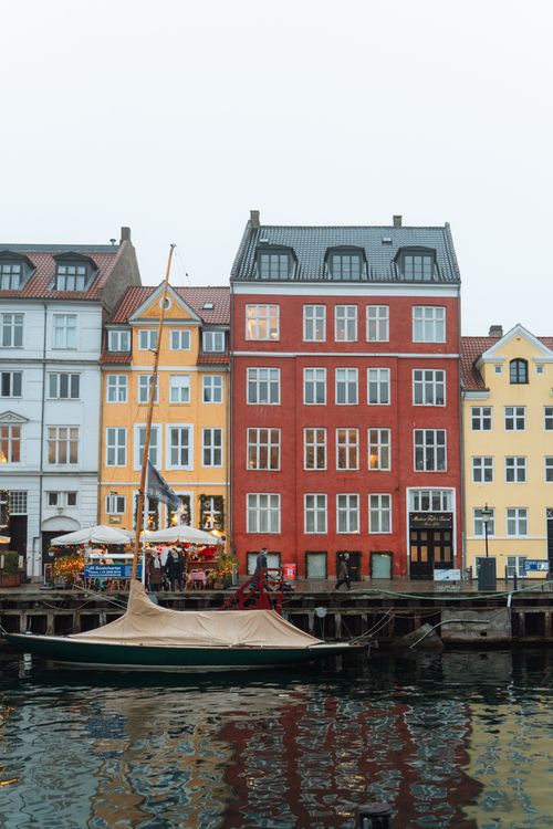Free Colorful buildings reflecting in the Nyhavn canal, a picturesque Copenhagen landmark. Stock Photo
