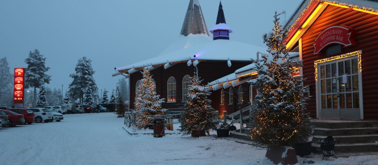 A festive twilight scene of Santa Claus Village in snowy Rovaniemi, Lapland, Finland.