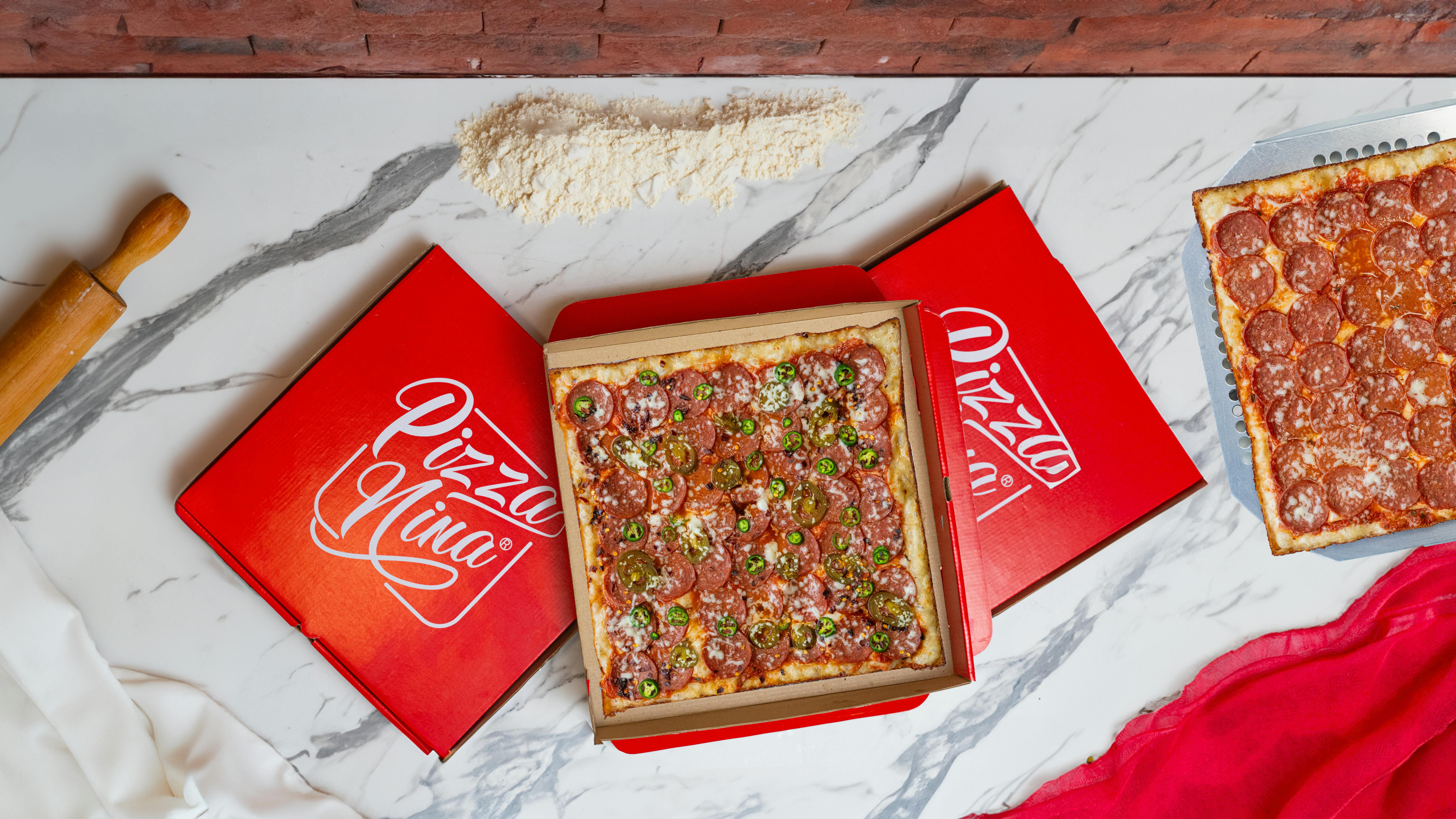 Square pepperoni pizza with jalapeños in a Pizza Nina box, Baghdad, Iraq.