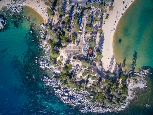 Free Stunning aerial shot of Lake Tahoe's beach and landscape with crystal-clear waters and lush greenery. Stock Photo