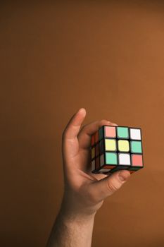 hand holding a partially solved 3x3 cube