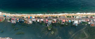 Top View Photo of Village Near Shoreline