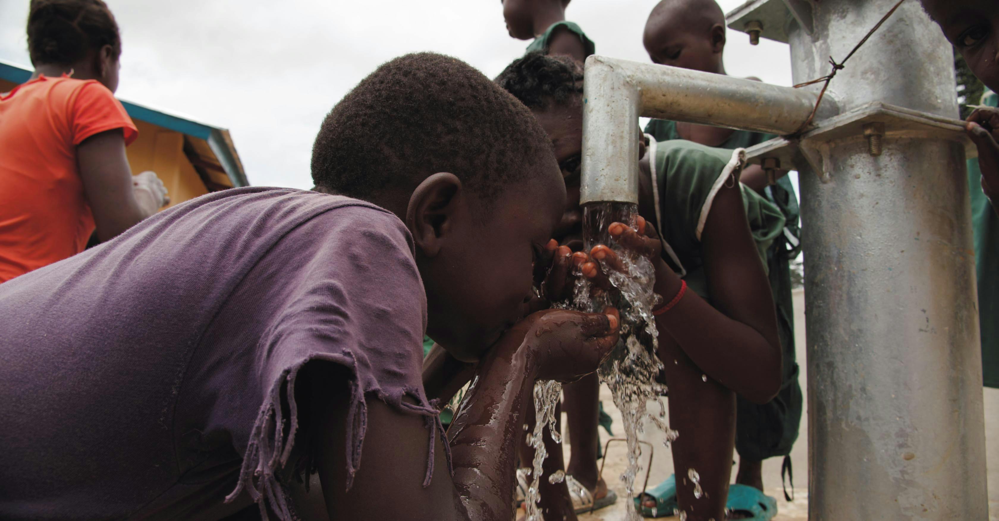 Closeup Of Two Children Drinking Water on Water Pump · Free Stock Photo