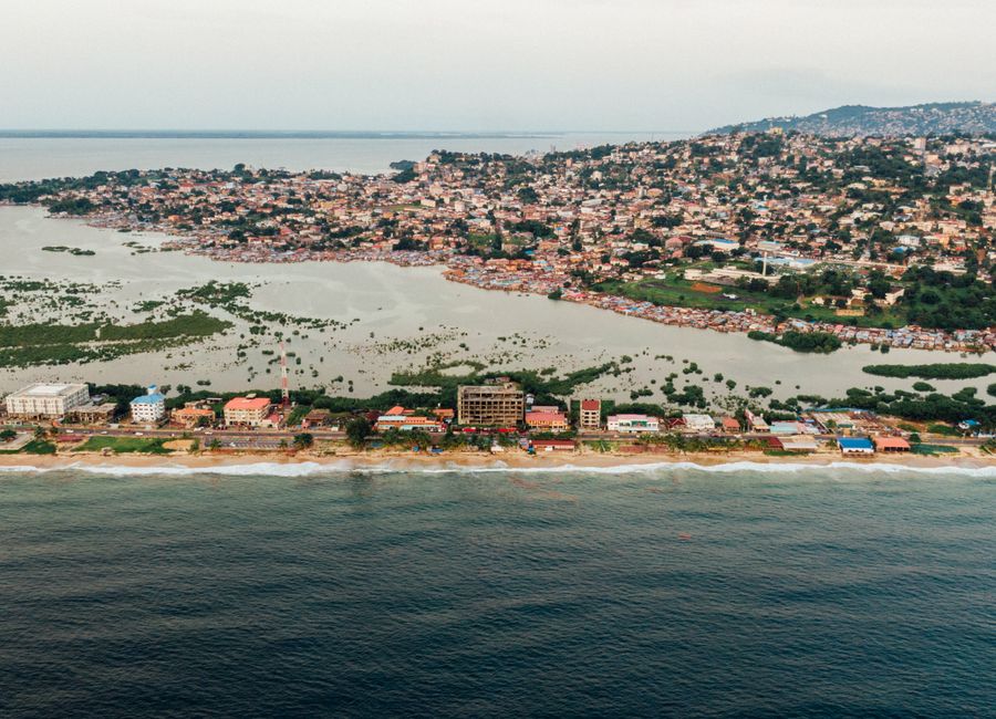 A stunning aerial view of a coastal city with a prominent harbor and lush greenery.
