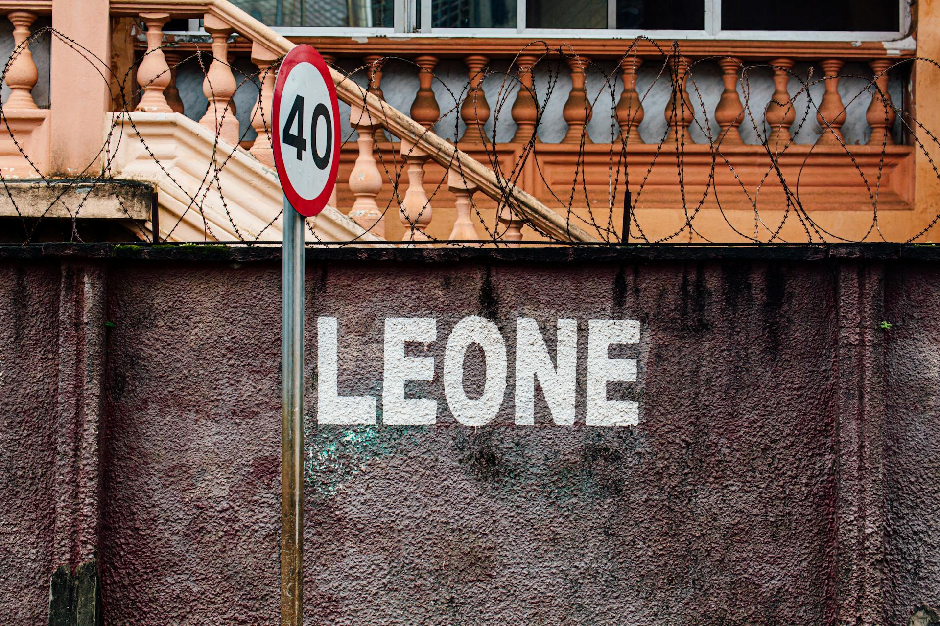 Gray 40 Road Sign Beside Wall With Leone Paint