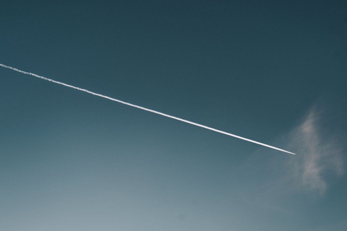 Contrail One Aerial View of Contrail Against Clear Sky · Free Stock Photo