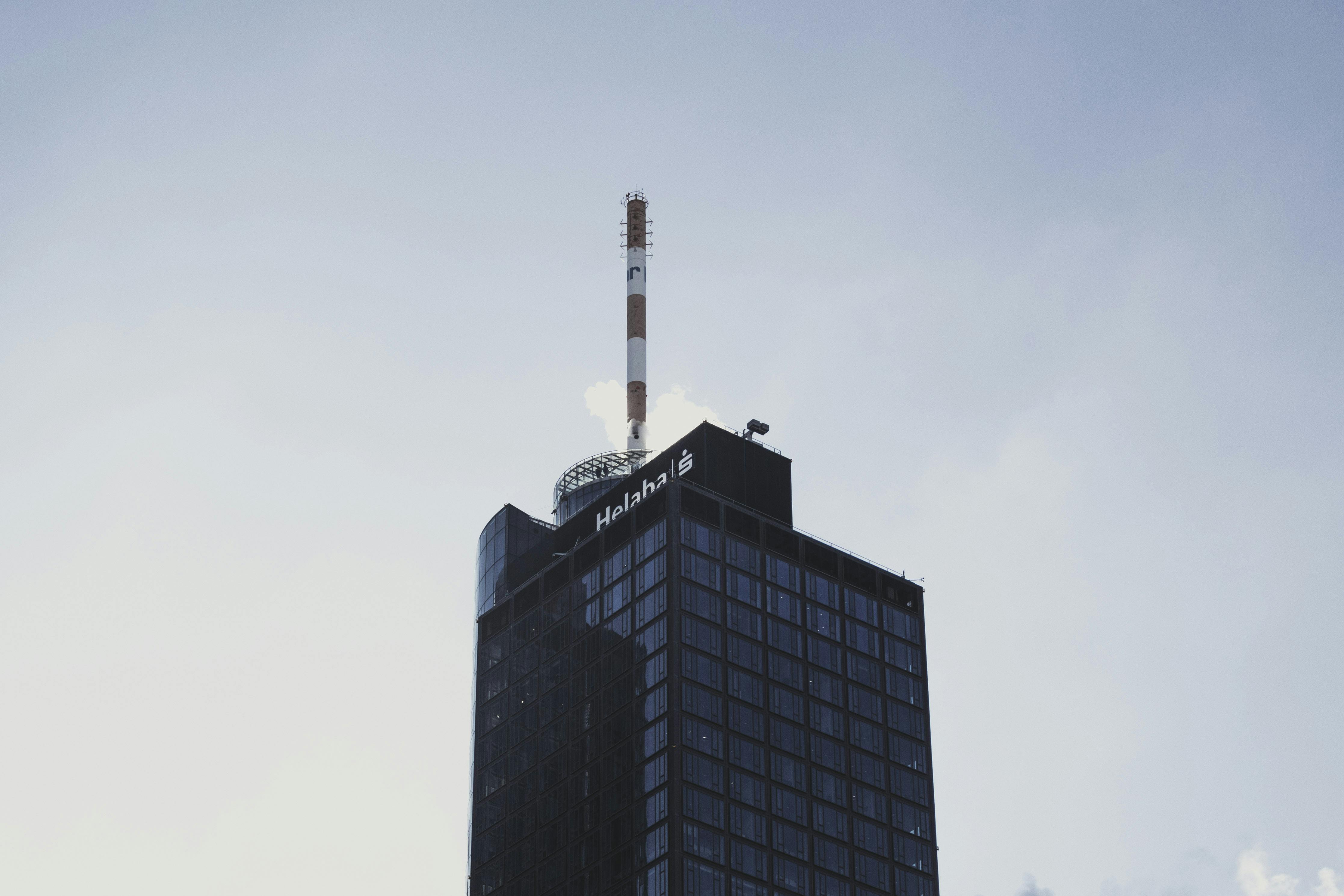 A striking modern highrise building in Frankfurt against a clear sky, showcasing contemporary architecture.