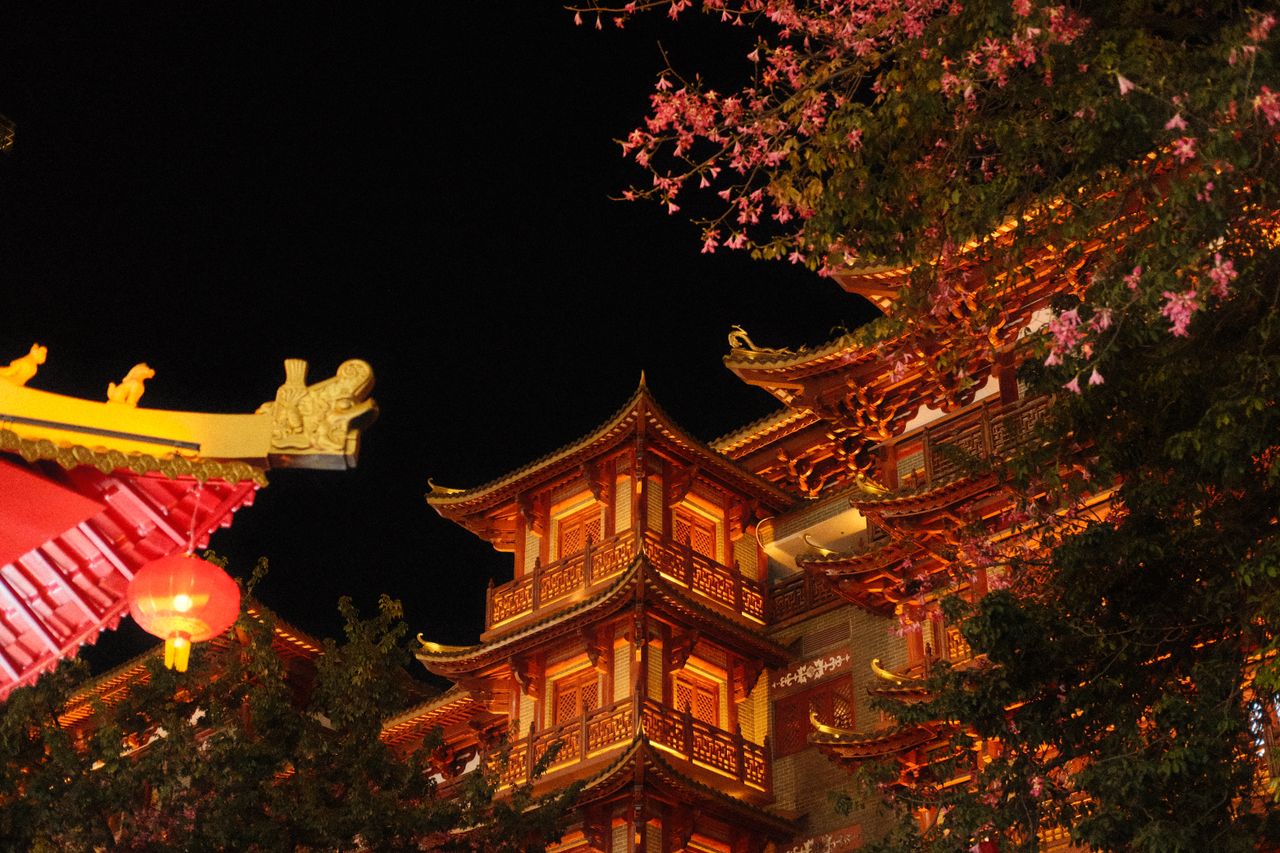 illuminated asian architectural building at night with ornate details