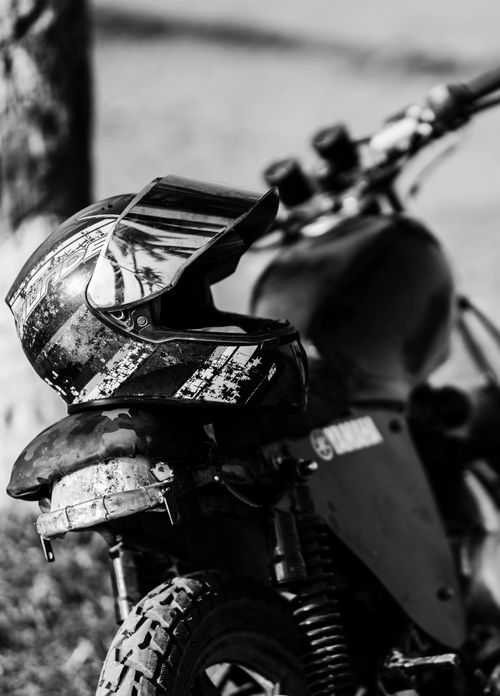 Free Monochrome image of a motorcycle with a helmet in focus. Stock Photo