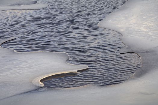 A captivating image of abstract ice formations merging with water ripples, showing nature's beauty.